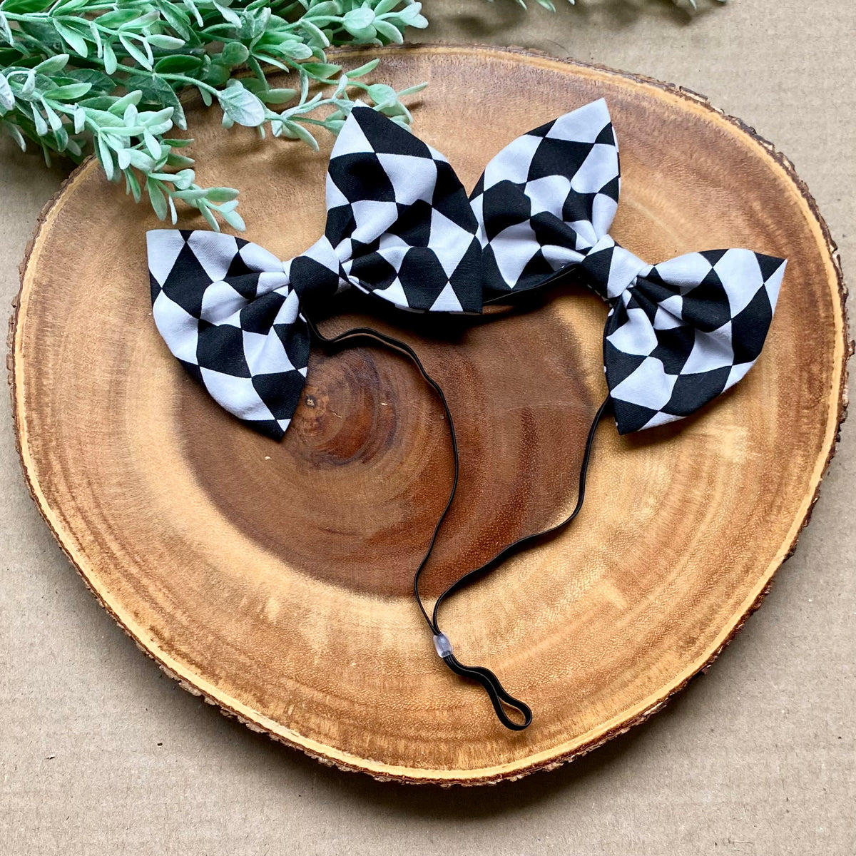 Checkered dog double bows by Bully Love Boutique featuring stylish black and white checkered fabric for pet accessories.