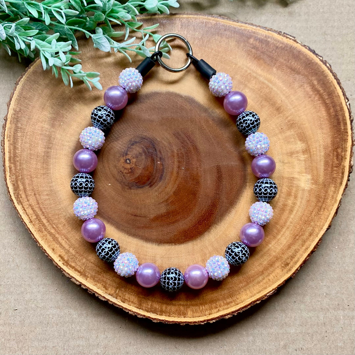 Purple spiderwebs beaded dog collar by Bully Love Boutique, featuring colorful beads and a playful spiderweb design.