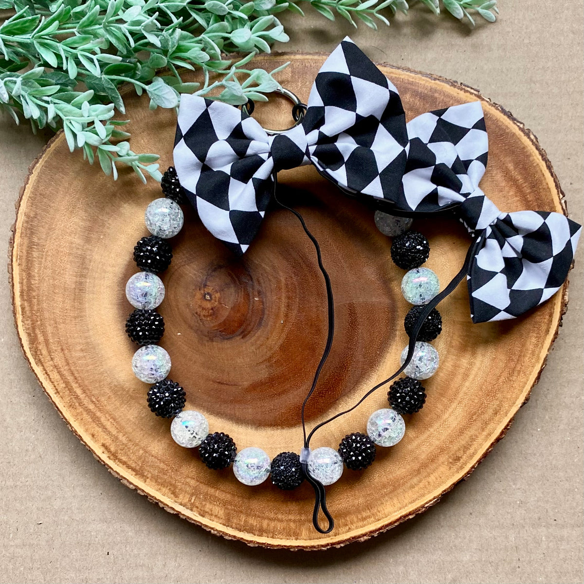 Checkered dog double bows from Bully Love Boutique featuring stylish black and white checkered patterns on fabric accessories.